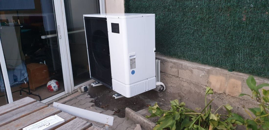 Unité extérieure de pompe à chaleur posée par Rev'Iso dans un jardin